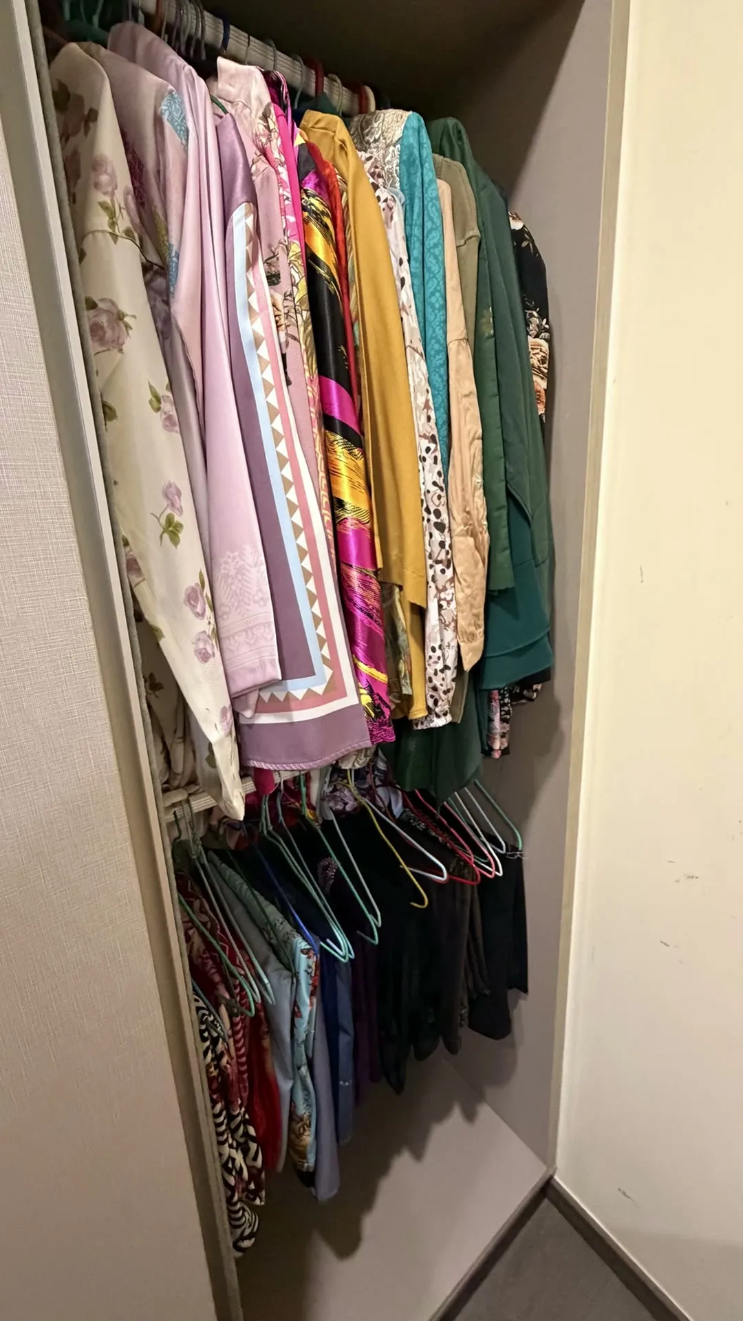 A wardrobe of neatly hung clothes, from a Space Edit transformation video